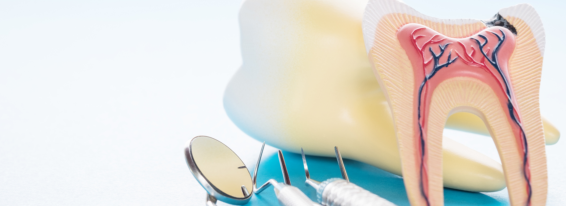 An image featuring a toothbrush, dental floss, and a mouth model with a cavity, set against a blue background.